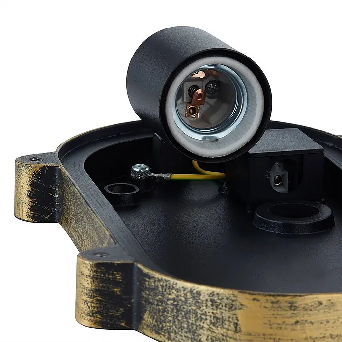 Lindby Außenwandleuchte Daaje - bronze / altmessing, IP44 - Nahaufnahme einer schwarz-gold patinierten Leuchtenbasis mit E27-Fassung und internen elektrischen Anschlüssen.