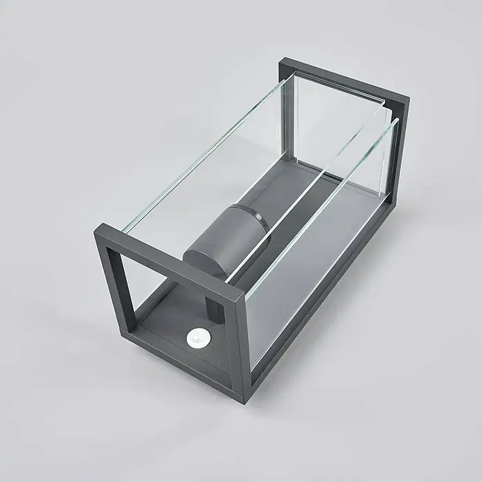 Lucande Außenwandleuchte Annalea - schwarz, klar / transparent, IP54 - Dunkelgraue Metall-Außenwandleuchte mit klaren Glaspaneelen und weißem Sensor.