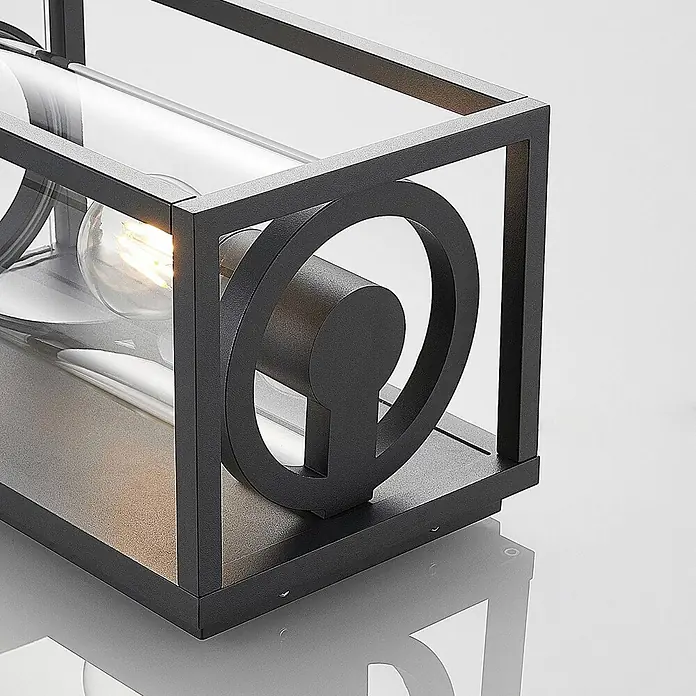 Lucande Außenwandleuchte Brienne - alu / grau / zink, IP54 - Dunkle Metallrahmen-Leuchte mit Glaszylinder und warmer Glühbirne, mit dekorativem Kreiselement.