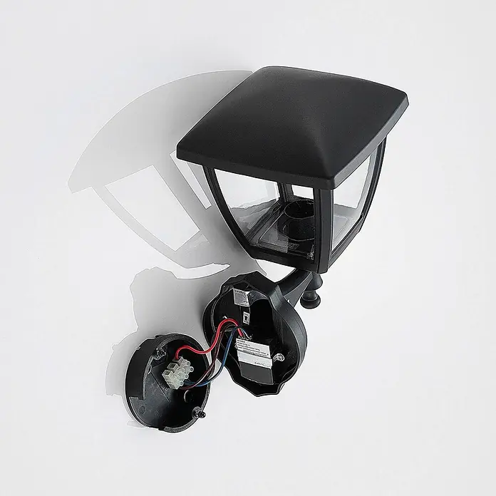 Lindby Außenwandleuchte Acelya - schwarz, schwarz, IP44 - Schwarze Außenwandleuchte mit klarem Laternen-Design, offen gezeigt mit freiliegender Verkabelung zur Installation.