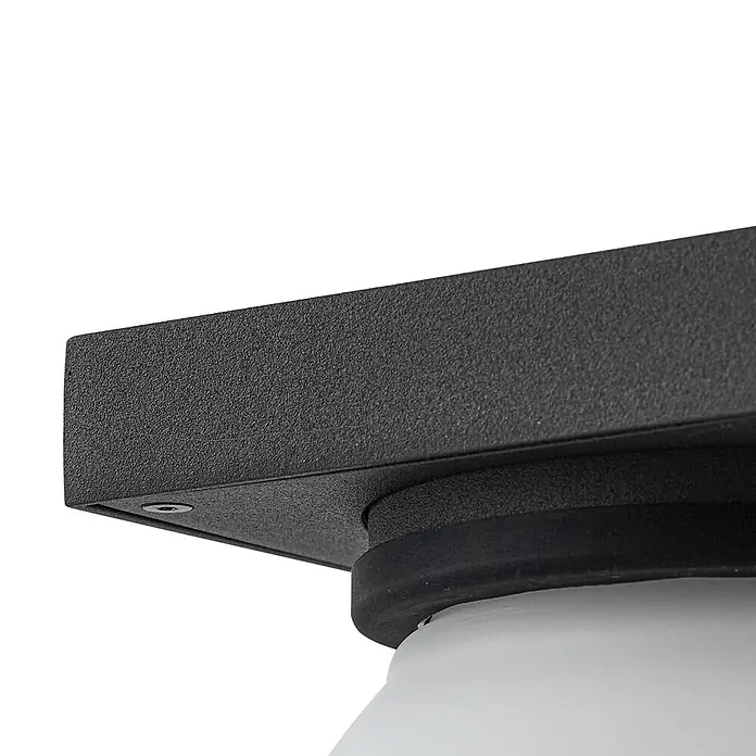 Lucande Außenwandleuchte Ovaali - schwarz, IP65 - Schwarze, strukturierte Quadratbasis einer Leuchte mit Schraube, Gummidichtung und weißem Diffusor.