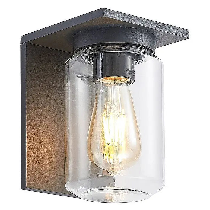 Lucande Außenwandleuchte Semka - schwarz, klar / transparent, IP54 - Anthrazitfarbene Außenwandleuchte mit klarem Glaszylinder und sichtbarer Edison-LED-Lampe, an eckiger Halterung.