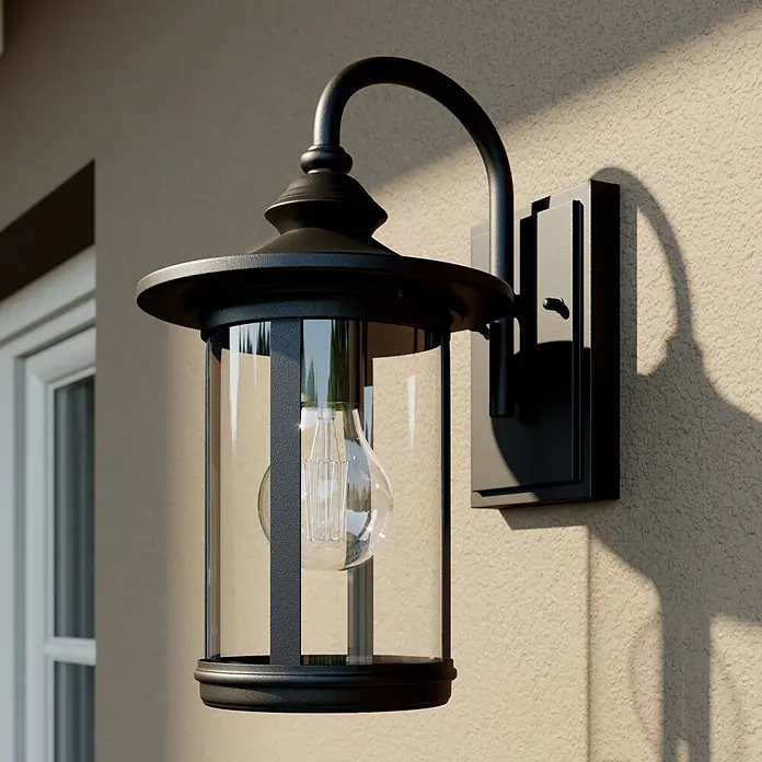 Lindby Außenwandleuchte Zayn - 23,8 x 19 x 33,4 cm, schwarz, IP23 - Schwarze Außenwandleuchte aus Metall mit Klarglas und Edison-Glühbirne, an beigefarbener Putzfassade montiert.