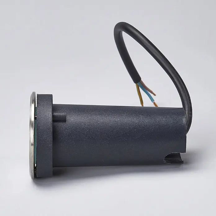 Lucande LED-Gartenstrahler Kenan - 3.000 K - Dunkelgraue zylindrische Einbauleuchte mit silberner Frontblende und schwarzem Stromkabel mit offenen Adern.