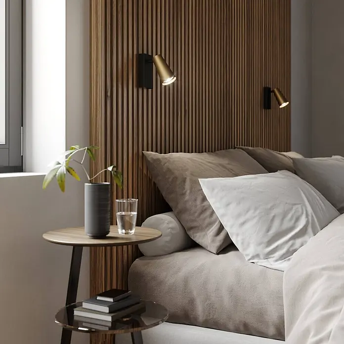 Lucande Wandstrahler Angelina - L x B x H: 16 x 6,5 x 13 cm, schwarz, messing / gold, GU10 - Modernes Schlafzimmer mit neutralfarbener Bettwäsche, Latten-Kopfteil aus Holz und minimalistischem Beistelltisch. Wandleuchten beleuchten den Nachttisch.