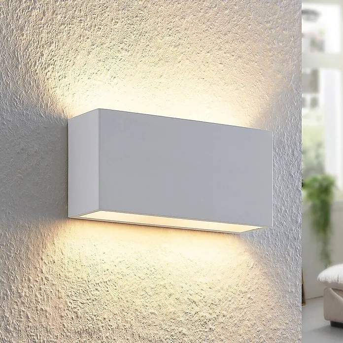 Lindby Wandleuchte Mavora - L x B x H: 7 x 25 x 12 cm, weiß / opal, G9 - Weiße rechteckige Wandleuchte, die warmes Ober- und Unterlicht auf eine strukturierte Wand wirft.