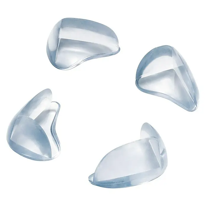Inofix Protector para esquina 5001-0- - Transparente, 8 ud. - Imagen de cuatro protectores de esquinas transparentes, diseñados para proteger a bebés y niños de las esquinas afiladas.