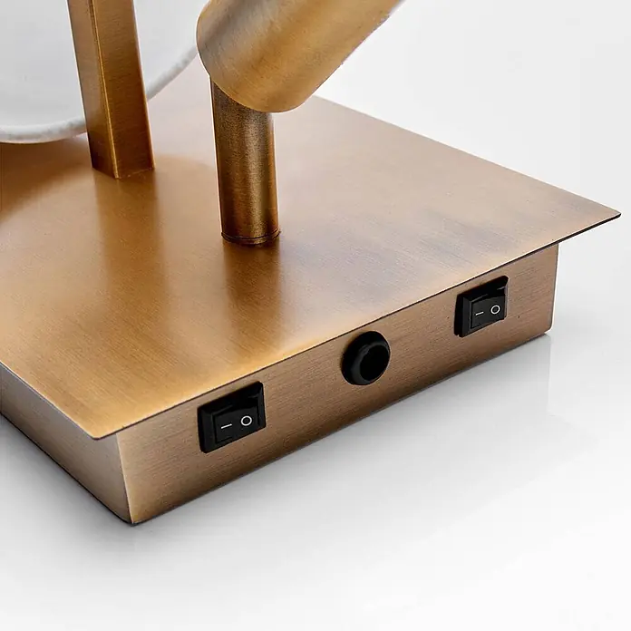 Lindby Wandleuchte Aiden - bronze / altmessing - Lampenfuß aus antikem Messingmetall mit zwei schwarzen Kippschaltern und einer runden Öffnung.