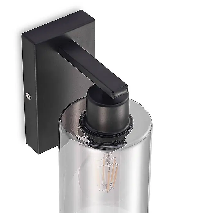 Lindby Wandleuchte Emavi - L x B x H: 15 x 10 x 23 cm, schwarz, schwarz, E27 - Schwarze Metall-Wandleuchte mit zylindrischem Klarglasschirm und sichtbarer Glühbirne.