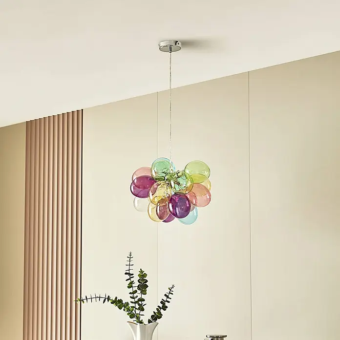 Lucande Pendelleuchte Diborah - L x B x H: 40 x 40 x 30 cm, Multicolour, multicolour, G9 - Ein bunter Kronleuchter aus verschieden großen Glasblasen hängt von der Decke in einem modernen Raum.