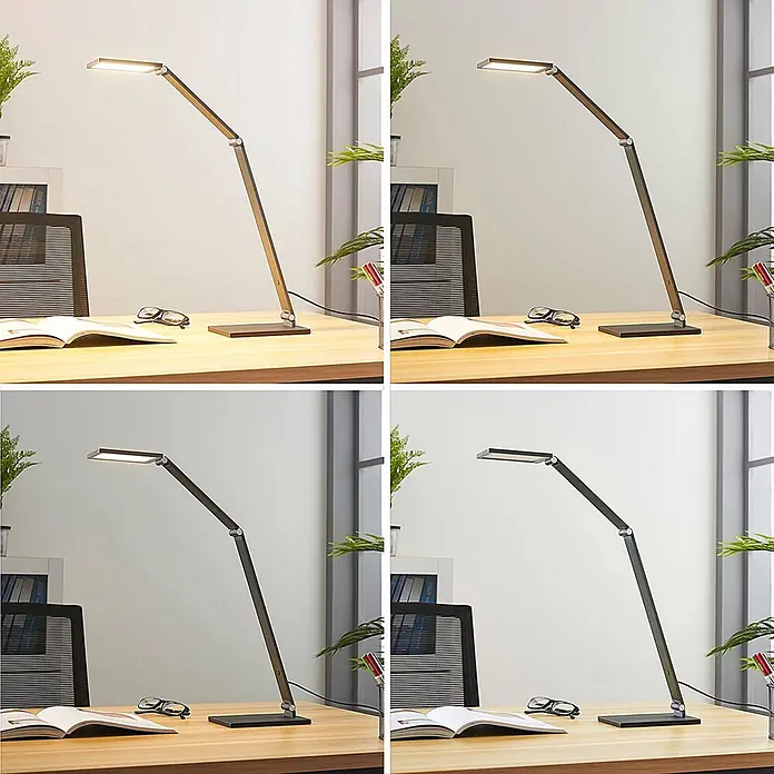 Lucande Tischleuchte Mion - L x B x H: 36,5 x 12 x 41 cm, alu / grau / zink, alu / grau / zink - Moderne dunkelgraue verstellbare LED-Schreibtischlampe beleuchtet einen Holzschreibtisch mit Buch und Brille.
