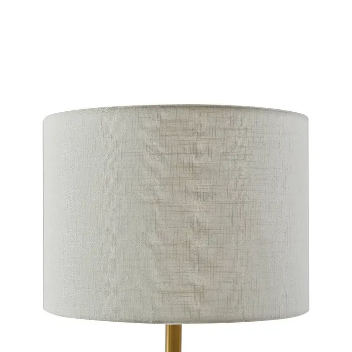 Lindby Tischleuchte Alabaster - alu / grau / zink, weiß / opal, E27 - Cremefarbener zylindrischer Lampenschirm aus strukturiertem Stoff, mit goldfarbenem Lampenfuß sichtbar.