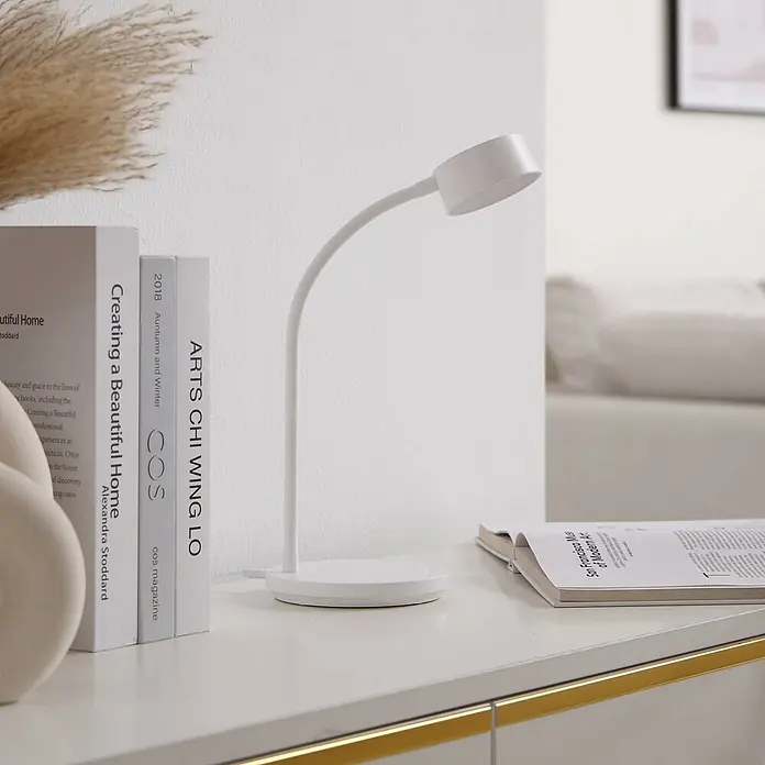Lindby Tischleuchte Maori - L x B x H: 13 x 13 x 38,5 cm, weiß / opal, weiß / opal - Weiße, minimalistische Schreibtischlampe mit flexiblem Schwanenhals, auf einem hellen Schreibtisch neben Büchern platziert.