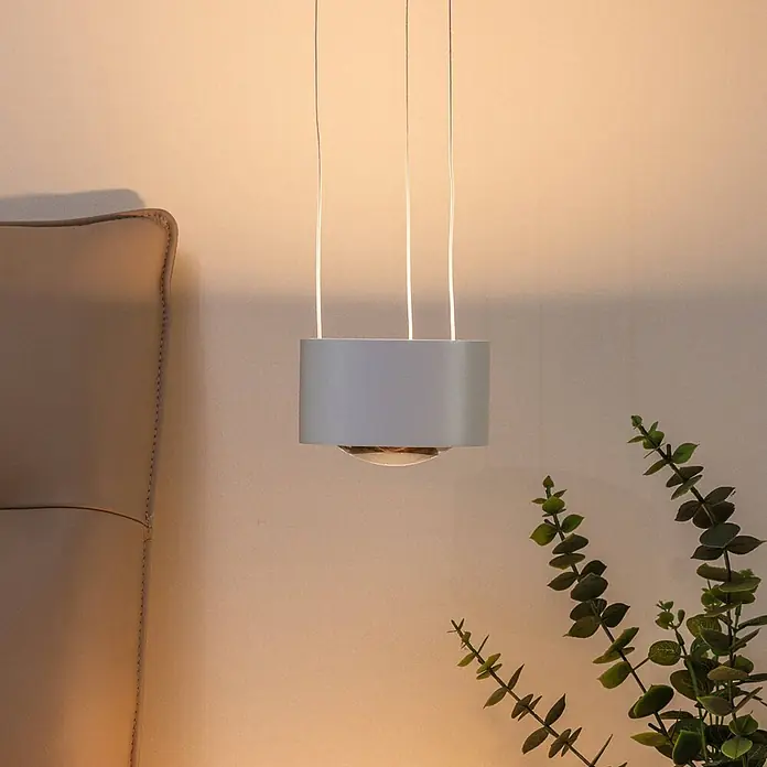 Arcchio Pendelleuchte Rotari - L x B x H: 12 x 12 x 9,3 cm, weiß / opal, weiß (RAL 9003) - Graue zylindrische Pendelleuchte an drei Aufhängedrähten, die ein warmes Licht in einen Raum wirft.