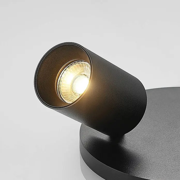 Arcchio Deckenstrahler Brinja - schwarz, schwarz, GU10 - Schwarzer zylindrischer Strahler mit warmweißem Licht, auf rundem Sockel montiert.