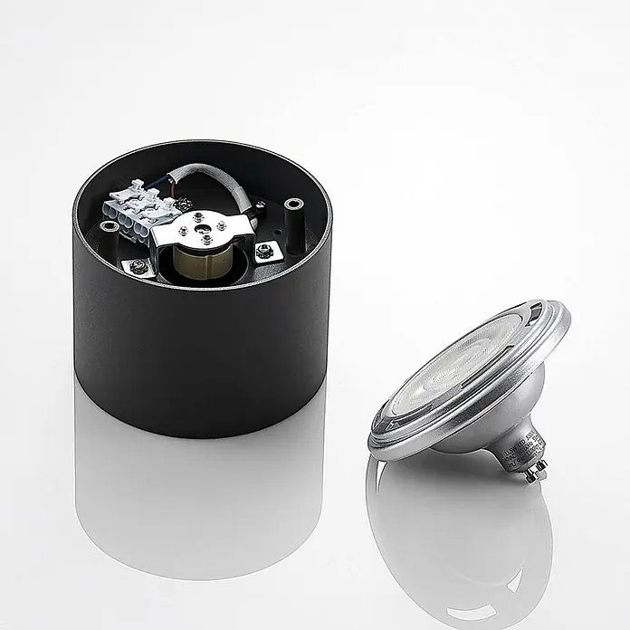 Arcchio Deckenstrahler Mabel - alu / grau / zink, alu / grau / zink, GU10 - Schwarzes zylindrisches Leuchtengehäuse mit sichtbarer Innenverkabelung und separater silberner LED-Glühbirne.
