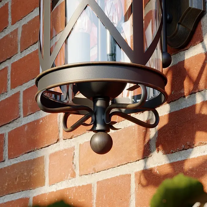 Lucande Außenwandleuchte Marcellino - braun / rost, braun / rost, IP23 - Dunkelbronze-Metall- und Klarglas-Außenwandleuchte an einer rustikalen Ziegelwand montiert.
