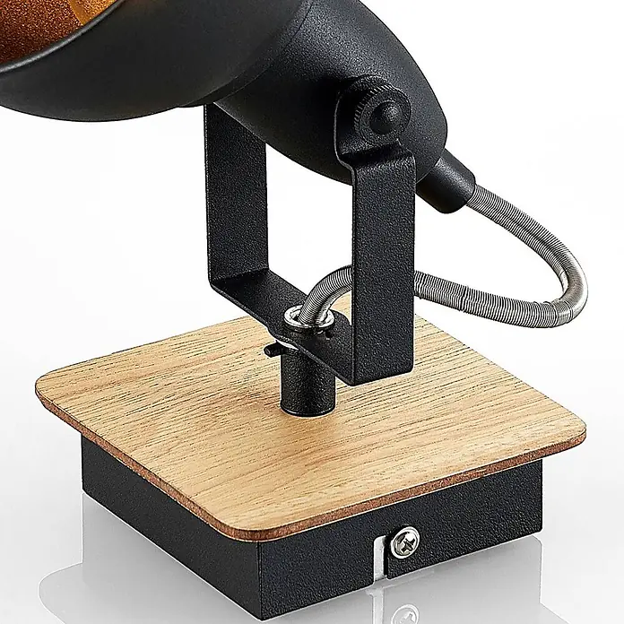 Lindby Wandstrahler Aylis - Holz dunkel, schwarz, E14 - Schwarzer Metall-Lampenfuß mit heller Holzplatte und verstellbarem schwarzem Metallarm mit flexiblem Silberrohr.