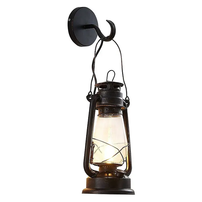 Lindby Wandleuchte Raisa - braun / rost, E14 - Rustikale schwarze Metall-Wandleuchte im Laternen-Design mit klarem Glasschirm und sichtbarer Glühbirne, auf runder Basis montiert.