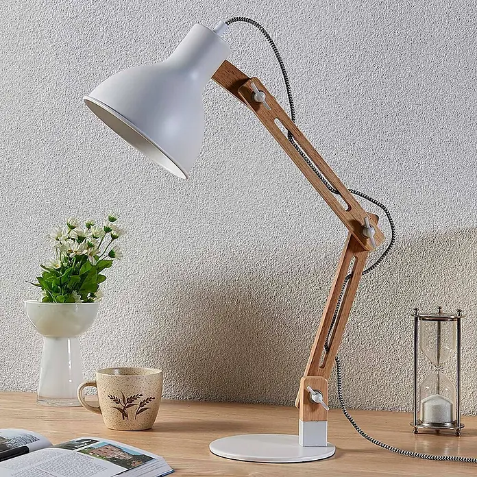 Lindby Tischleuchte Shivanja - L x B x H: 42 x 18 x 46 cm, Holz hell, E27 - Weiße verstellbare Schreibtischlampe mit Holzarmen und geflochtenem Kabel auf einem Schreibtisch.