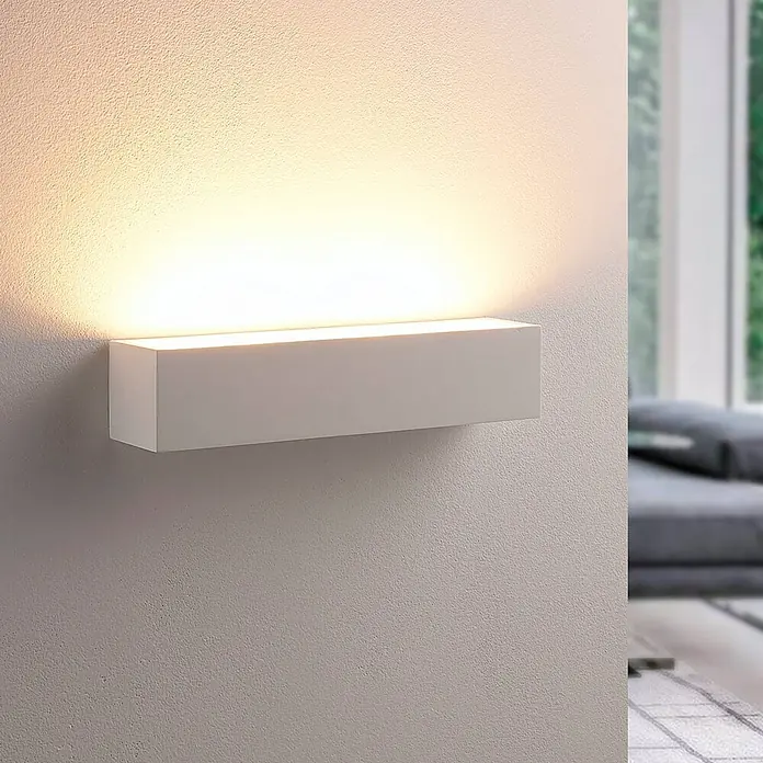 Lindby Wandleuchte Santino - L x B x H: 7,5 x 35,3 x 7,5 cm, weiß / opal, G9 - Weiße rechteckige LED-Wandleuchte an einer strukturierten Wand, die warmes Licht nach oben und unten wirft.
