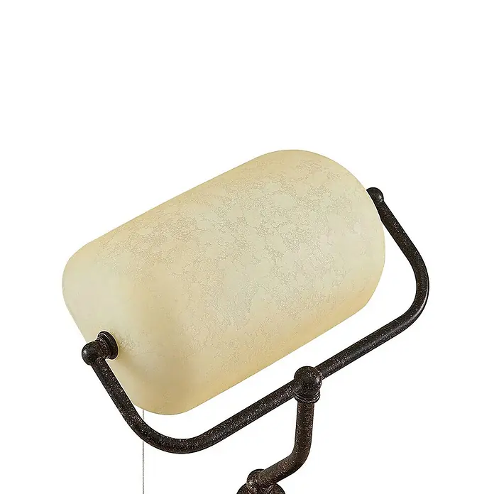 Lindby Tischleuchte Profina - L x B x H: 18,5 x 27,2 x 38,5 cm, braun / rost, creme / amber, E27 - Zylindrischer Lampenschirm aus cremefarbenem Milchglas, montiert auf einem verzierten, dunklen Metallrahmen.