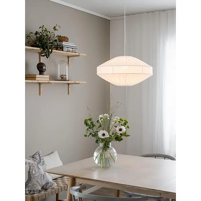 PR Home Pendelleuchte 50cm - 15 W, E27 - Weiße Pendelleuchte aus plissiertem Stoff, die einen hellen Esstisch aus Holz beleuchtet.