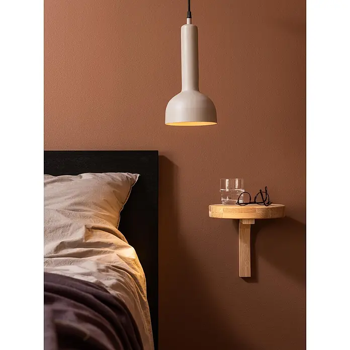 PR Home Pendelleuchte Bainbridge - 25 W, E27 - Helle beige Pendelleuchte beleuchtet ein Schlafzimmer mit einem wandmontierten Nachttisch aus hellem Holz, Glas und Brille.