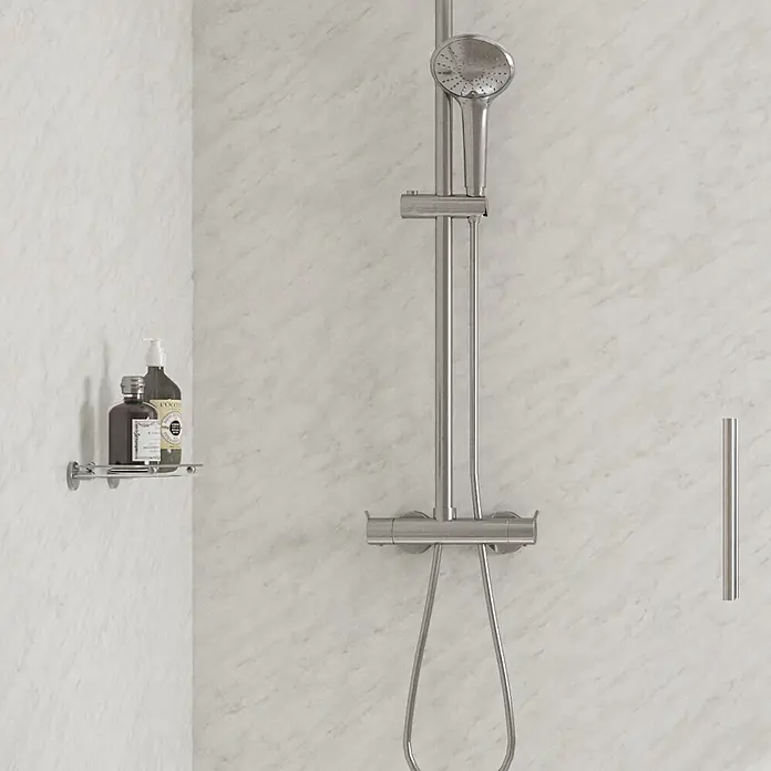 Wetwall Wandpaneel Elite - 16 x 242 cm, Carrara Marble, Abgerundete Kante - Gebürstetes Metall-Duschsystem mit Handbrause, Mischer und Schlauch an einer Marmorwand.