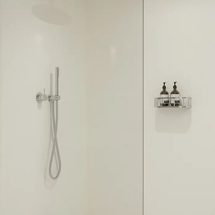 Wetwall Wandpaneel Elite - 16 x 242 cm, Blanco Frost, Abgerundete Kante - Chrom-Handbrause und Mischer in einer Dusche, daneben ein Metallkorb mit zwei dunkelbraunen Pumpspendern.