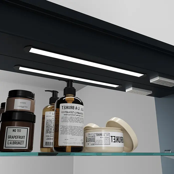 Disbain Armario con espejo LED Kenya - An x Al: 80 x 75 cm, Metal, Vidrio - Productos cosméticos, incluyendo L:A Bruket y Dior, en un estante de vidrio bajo un gabinete oscuro con luces LED.