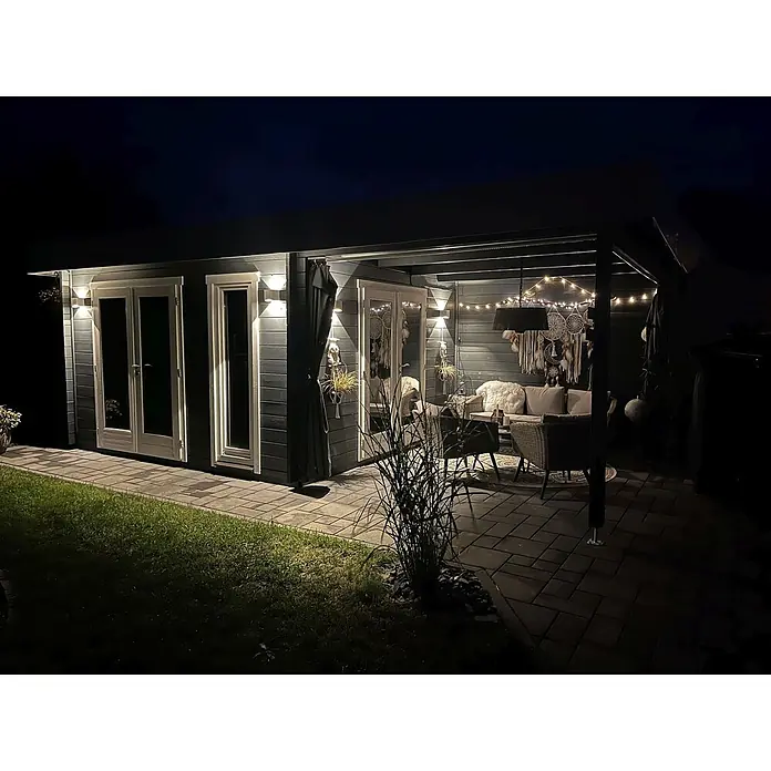 Fjordholz Gartenhaus Ronya 44 Grau Imprägnierung - Außenmaß inkl. Dachüberstand (B x T): 632 x 360 cm, Holz, Naturbelassen - Beleuchtetes Gartenhaus mit gemütlicher Terrasse und Loungebereich bei Nacht.