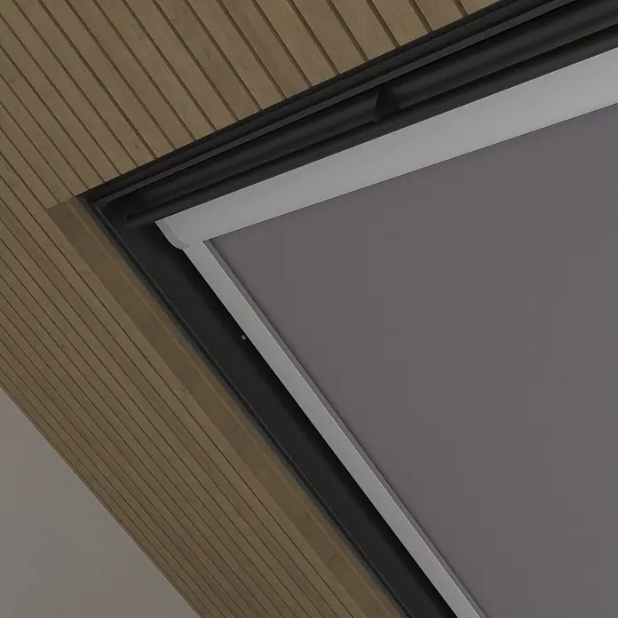 Dachfensterrollo Sky 2.0 - S06, Grau, Manuell - Graues Stoff-Rollo teilweise in einem Dachfenster ausgefahren, umrahmt von schwarzem Gehäuse und Holzlamellendecke.