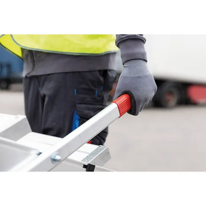 Munk Arbeitsplattform Arbeitspodest fahrbar Aluminium geriffelt 800mm Stufenbreite 5 Stufen - Anzahl Tritte: 5 Stk., Arbeitshöhe: 3.000 m, Aluminium - Person in Arbeitshandschuhen und Warnweste hält ein Aluminium-Rampen- oder Leitersegment mit rotem Griff.