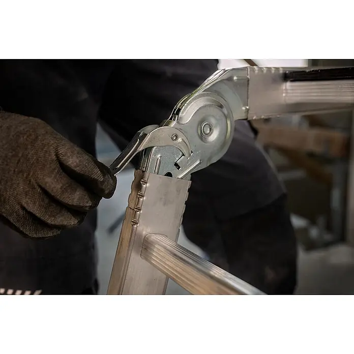 Werner Mehrzweckleiter Vielzweckleiter 4-teilig mit Plattform - Anzahl Tritte: 3 Stk., Arbeitshöhe: 4.540 m, Aluminium - Behandschuhte Hand stellt den Metallscharnier-Mechanismus einer Alu-Mehrzweckleiter ein.