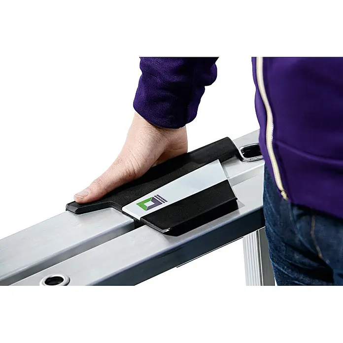 Munk Stehleiter Aluminium-Stehleiter 7 Stufen - Anzahl Tritte: 7 Stk., Arbeitshöhe: 3.650 m, Aluminium - Hand hält schwarzes und silbernes Schienensystem mit Logo, lila Ärmel sichtbar.