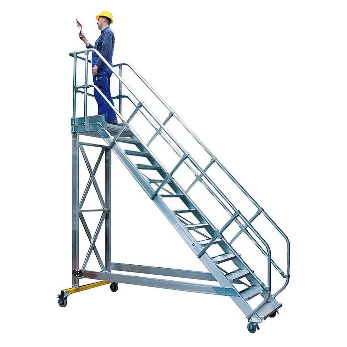 Munk Treppenpodest Plattformtreppe fahrbar 45° Stufenbreite 600mm 5 Stufen - Anzahl Tritte: 5 Stk., Aluminium - Mobile Aluminium-Arbeitsplattform mit Treppe und Geländern, mit Rollen ausgestattet. Ein Arbeiter steht auf der oberen Plattform.