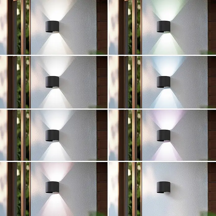 Lindby Außenwandleuchte Dara - alu / grau / zink, IP54 - Dunkle zylindrische Außenwandleuchte strahlt farbige Lichtkegel nach oben und unten auf eine strukturierte Wand.
