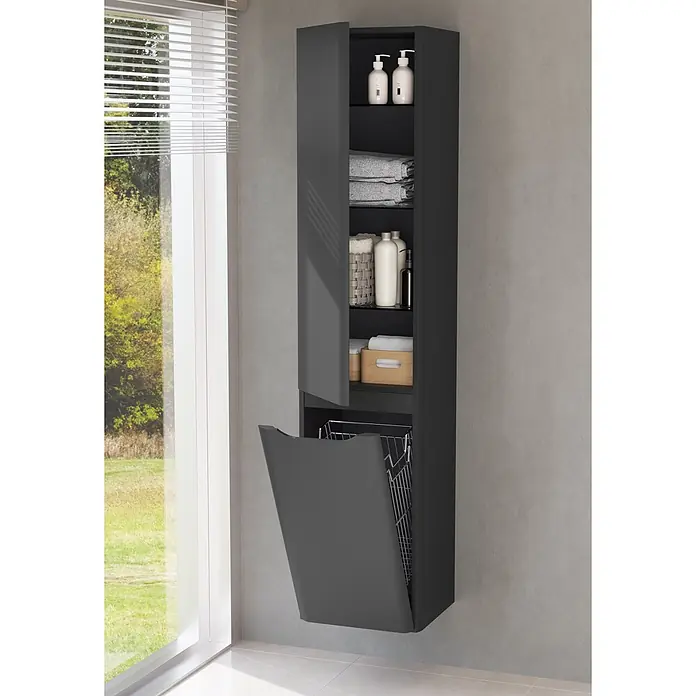 VitrA Hochschrank Integra Round - B x T x H: 40 x 37 x 180 cm, Graphit, DIN Anschlag: Links, Inklusive 3 Glasböden und Wäscheklappe - Hoher dunkelgrauer Badezimmerschrank mit Ablagen für Toilettenartikel und ausklappbarem Wäschekorb neben einem Fenster.