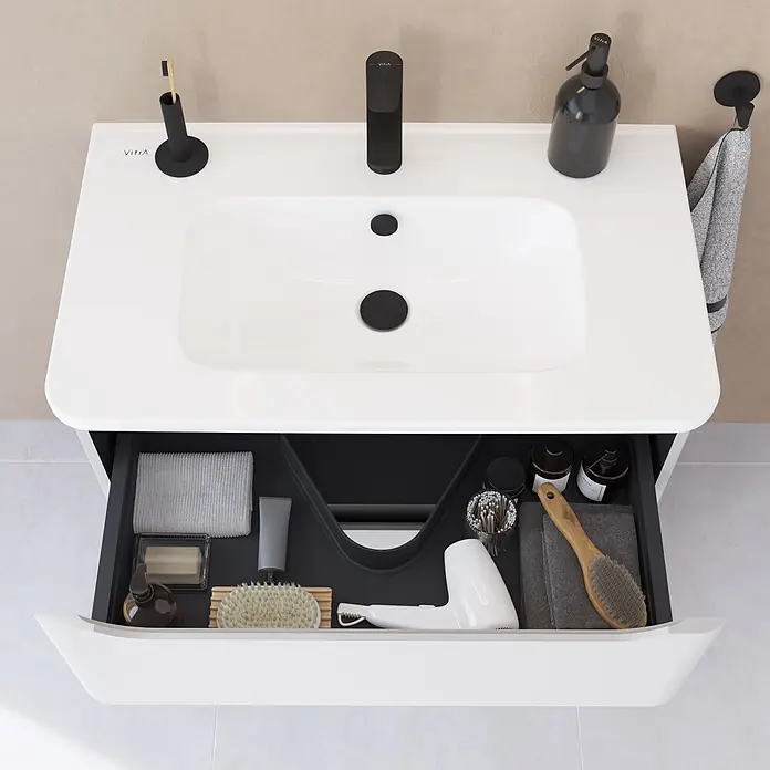 VitrA Integra Round Badmöbel-Set - Gesamtbreite Badmöbel: 80 cm, Hellgrau, Matt - Weißer Badwaschtisch mit integriertem Waschbecken und schwarzem Wasserhahn. Offene Schublade zeigt Toilettenartikel, Bürsten und Föhn.