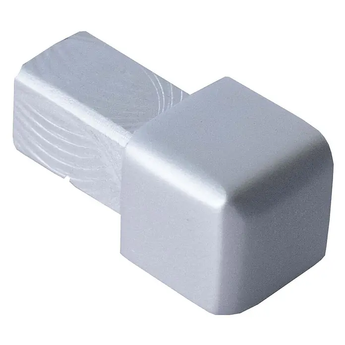 Dalsys Quadroprofil 8mm Endstück Quadratprofil Alu Silber matt, eloxiert - Aluminium, Silber - Silbergraue metallische Endkappe auf einem rauen, gefrästen Block.