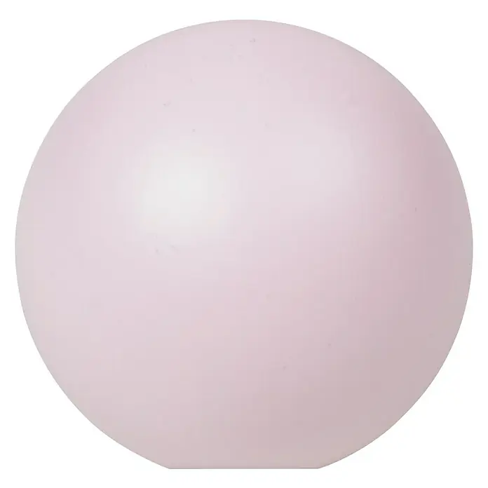 Nesu Pomo para muebles 445 Rosa - Tipo de tirador del mueble: Botón, Ø x Al: 40 x 37 mm, Madera - Primer plano de una lámpara redonda de color rosa claro que emite una luz suave sobre un fondo negro.