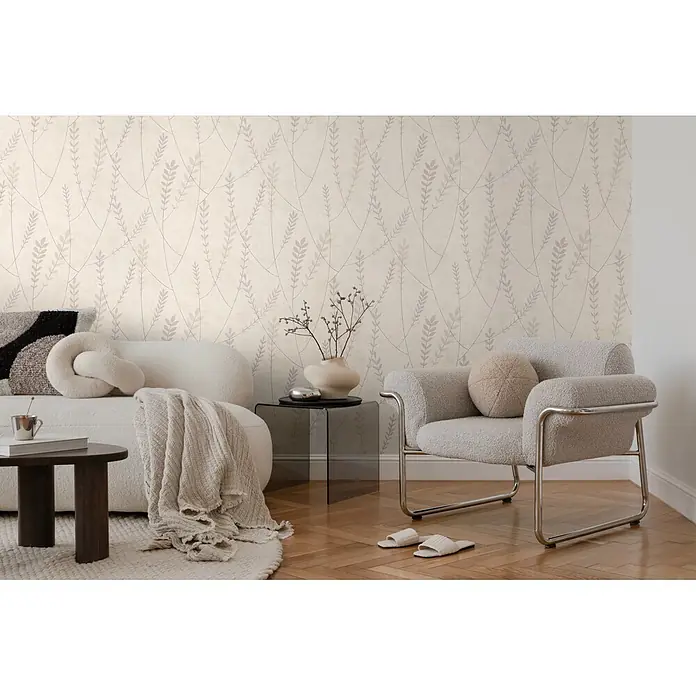 A.S. Création Nordic Feeling Vliestapete Skandi - Grau, Floral, 10,05 x 0,53 m - Tapete mit hellem Beigegrund und zartem botanischem Muster aus ineinander verschlungenen hellvioletten Blättern und Stielen, an einer Wohnzimmerwand.