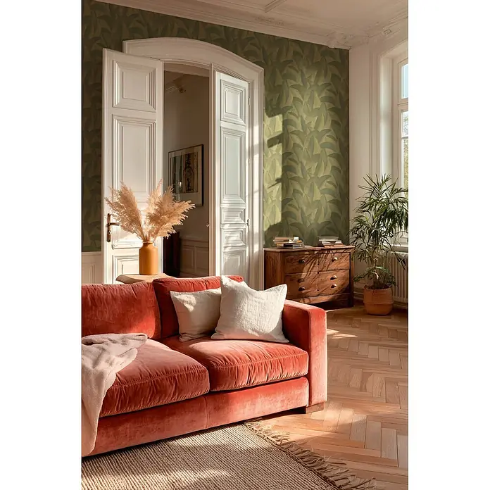 A.S. Création Metropolitan Stories Vibes & Styles Vliestapete Palme - Grün-Metallic, Floral, 10,05 x 0,53 m - Terrakotta-Samtsofa in einem sonnendurchfluteten Wohnzimmer. Mit hellen Kissen und einer Decke.