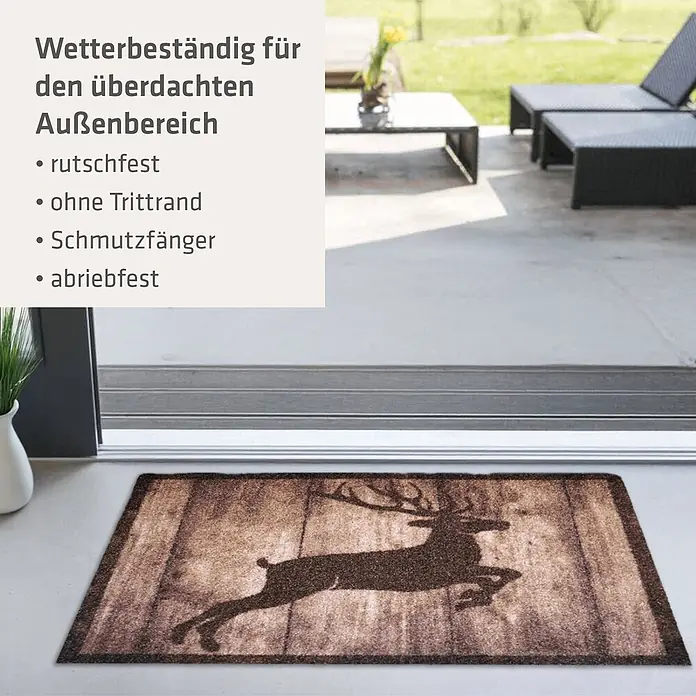 Akzente Fußmatte Listen - Mehrfarbig, Motiv / Muster|Tiere - Braune Fußmatte mit Hirschsilhouette, an einem überdachten Außeneingang platziert.