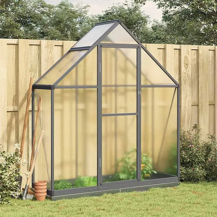Furnicato Gewächshaus Polycarbonat Anthrazit - 58 x 169 cm, Material Seitenwand: Kunststoff, 10 mm, anthrazit - Graues Aluminium-Gewächshaus mit durchsichtigen Platten, auf Rasen in einem Garten mit wachsenden Pflanzen.