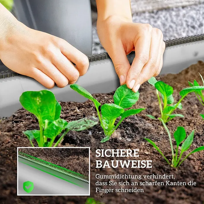 Outsunny Hochbeet - Stahl, Silber - Gartenbegrenzung mit schützender Gummidichtung, während Hände Sämlinge in einem Hochbeet pflanzen.