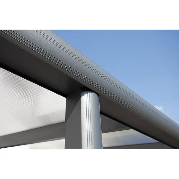 SKAN HOLZ Terrassenüberdachung Garda - B x T: 648 x 357 cm, Anthrazit, Polycarbonat, Transparent - Nahaufnahme eines grauen, texturierten Metallträgers und einer lichtdurchlässigen gerippten Dachplatte eines Vordachs vor blauem Himmel.