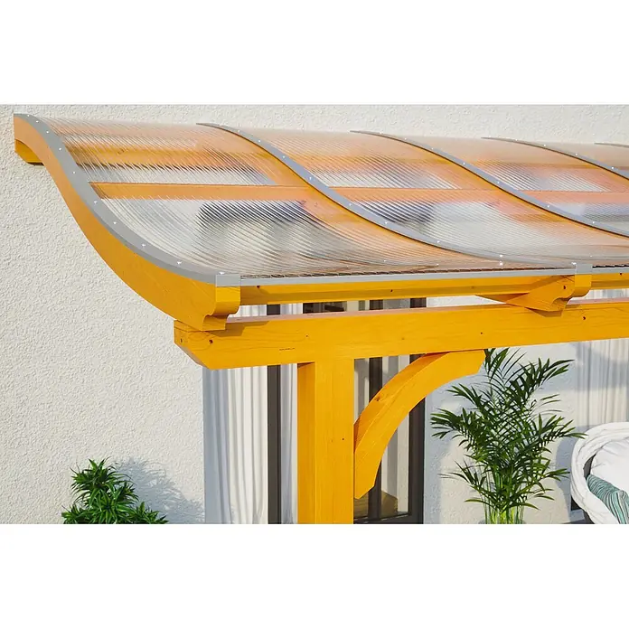 SKAN HOLZ Terrassenüberdachung Venezia - B x T: 434 x 389 cm, Eiche hell, Polycarbonat, Transparent - Holzpergola mit klarem Wellkunststoffdach und silberner Verkleidung, an einem Gebäude befestigt.