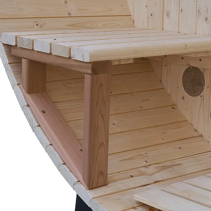 Home Deluxe Fasssauna LAGOM DELUXE - Holzofen, Holz - Helle Holzlattenbänke mit rötlich-braunen Stützen und integrierter Lüftung in einem Holzsauna-Innenraum.